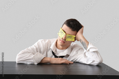 Tired young businessman wit...