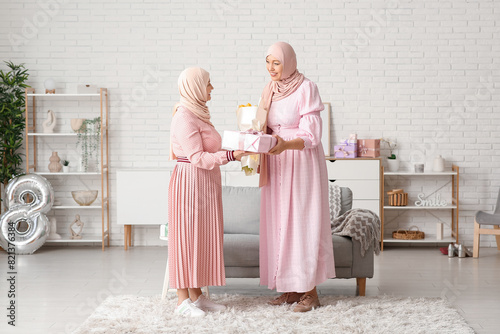 Muslim adult woman greeting...