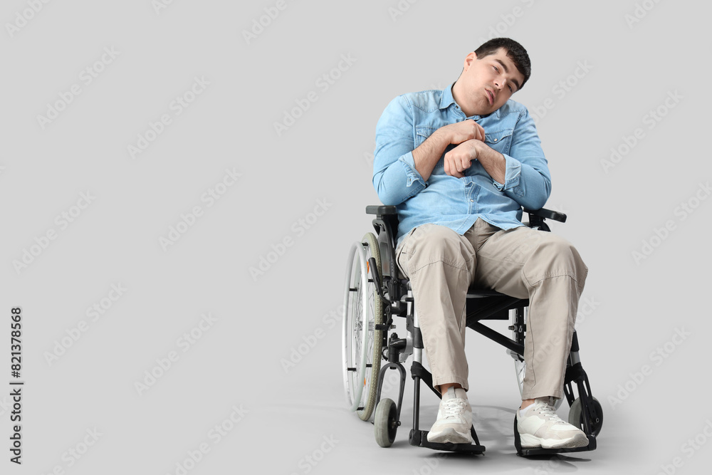 Young man in wheelchair on light background. National Cerebral Palsy Awareness Month Young man in wheelchair on light background. National Cerebral Palsy Awareness Month