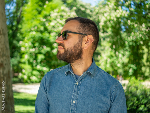 a bearded man with sunglasses in a natural environment