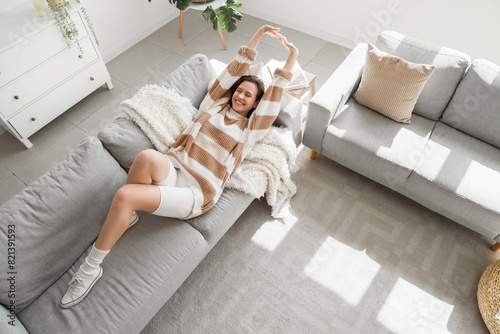 Young happy woman lying on ...