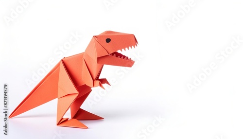 Animal extinct reptile or bird concept origami isolated on white background of a tyrannosaurus rex or T rex, with copy space, simple starter craft for kids