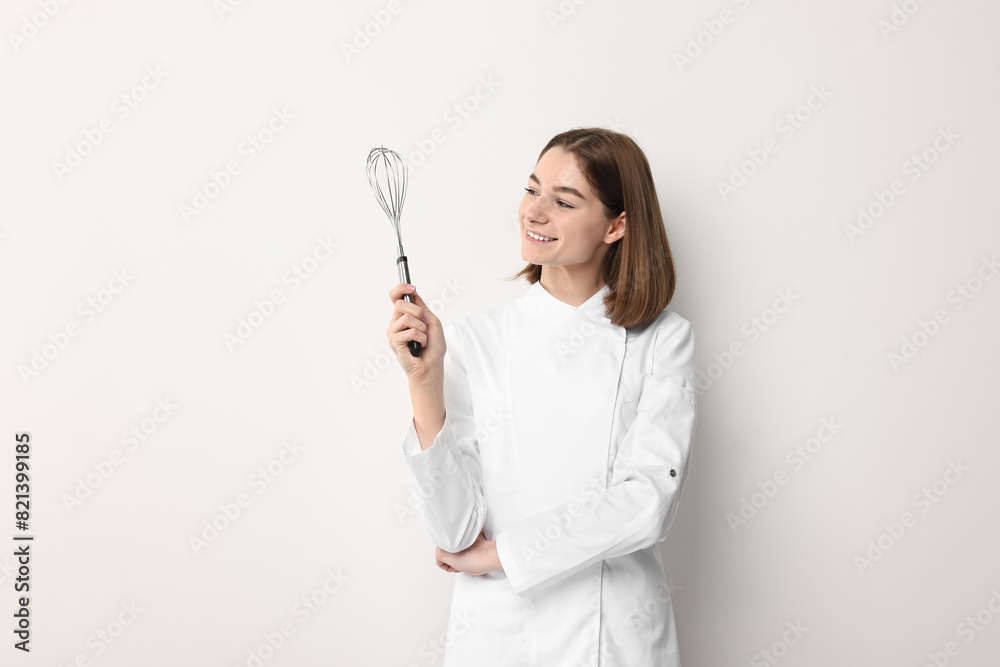 Professional chef with whisk on light background Professional chef with whisk on light background