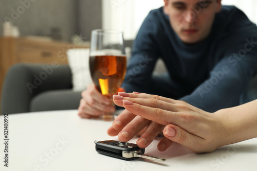 Fotografie Woman stopping drunk man from taking car keys, closeup