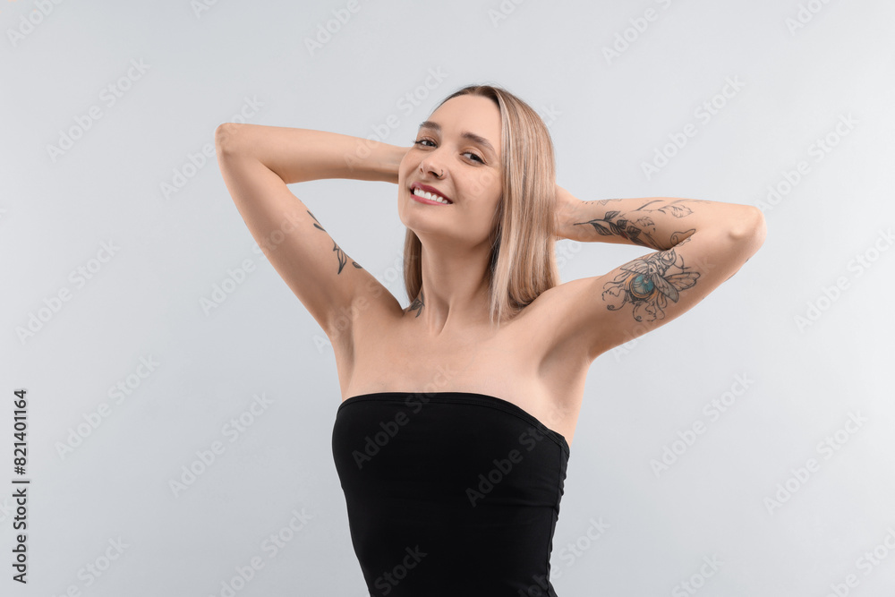 Portrait of beautiful tattooed woman on light background Portrait of beautiful tattooed woman on light background