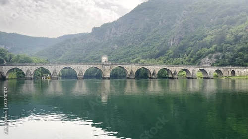 Visegrad, Bosnia and Herzegovina. Mehmed Pasha Sokolovic Bridge on Drina River. UNESCO World Heritage Site on a rainy Day photo