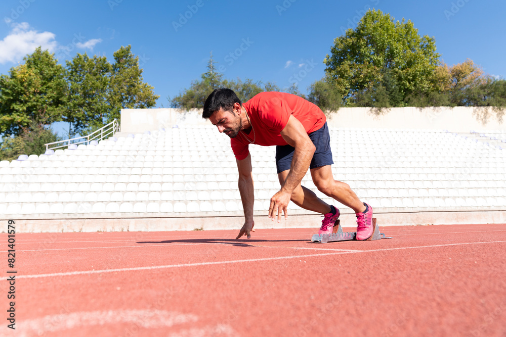 Fototapeta premium Stadium, man running and start block of athlete on a runner and arena track for sprint