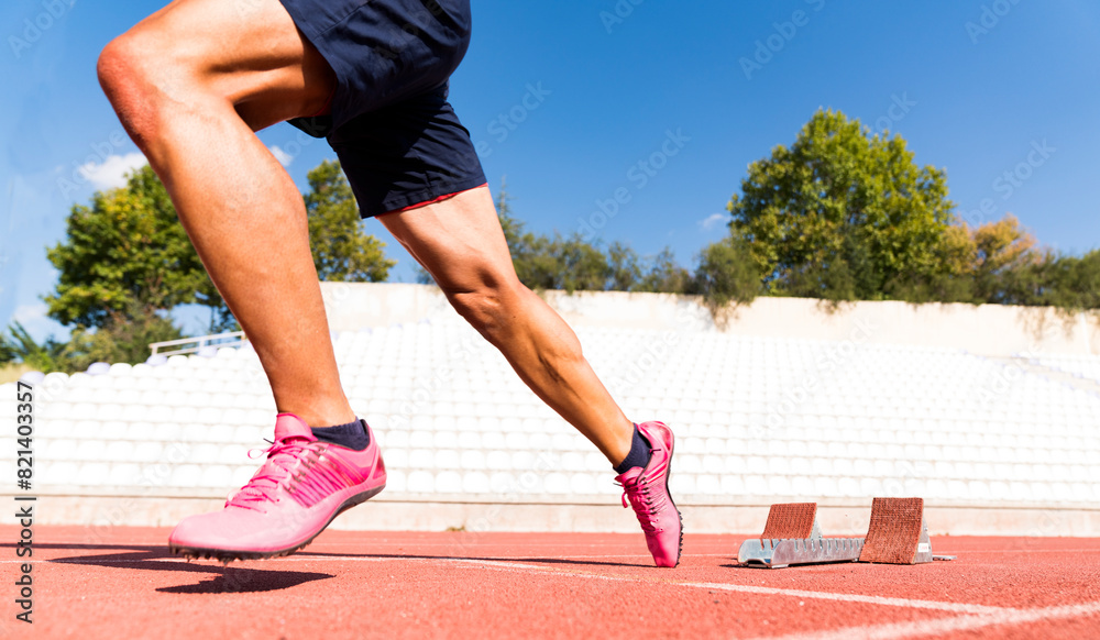 Stadium, man running and start block of athlete on a runner and arena track for sprint Stadium, man running and start block of athlete on a runner and arena track for sprint