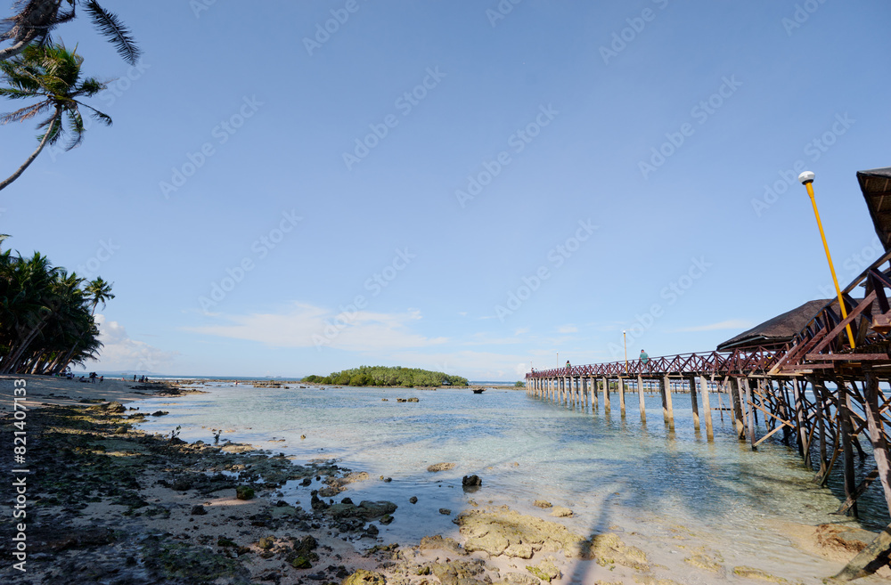 Beautiful landscape. Wooden bridge on Cloud 9 beach, Siargao Island Philippines.