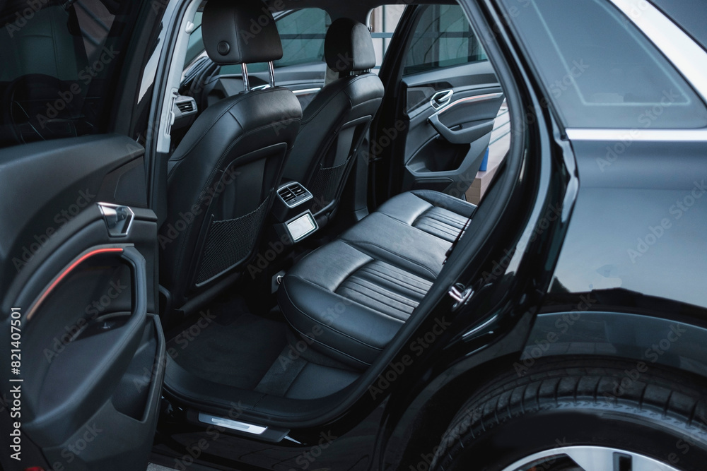 Modern black subcompact electric crossover SUV with black interior. Details interior. Modern black subcompact electric crossover SUV with black interior. Details interior.