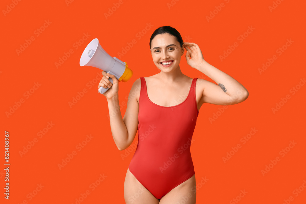 Female lifeguard with megaphone on orange background Female lifeguard with megaphone on orange background