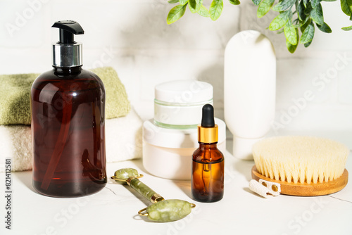 Bath background, beauty products in the bath shielf on white background. Cream, mask, soap, jade roller and face serum.