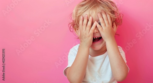 Kid Laugh. Beautiful Little Boy Covering Eyes with Hands, Laughing and Screaming on Pink Background