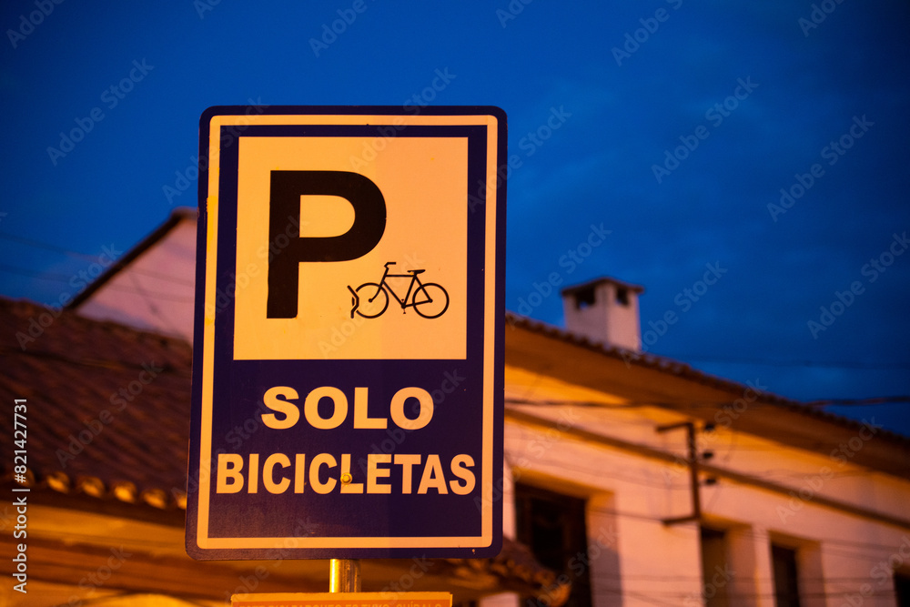 Fototapeta premium sign for a bicycle parking lot, isolated from the background at night