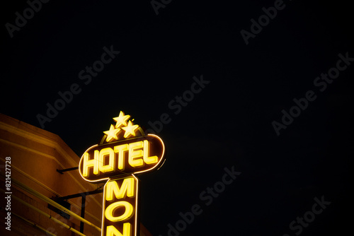 Retro neon Hotel sign, on the facade of a building, at night, with copy space