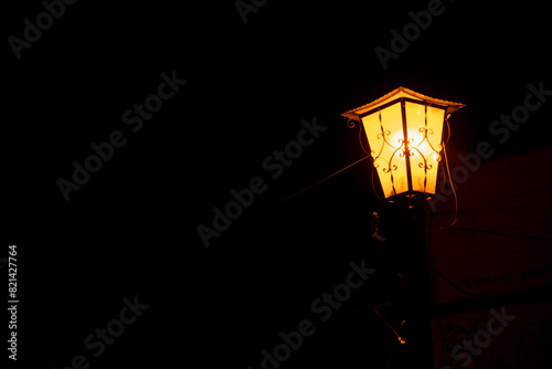 street light illuminating in the dark of the night, with copy space
