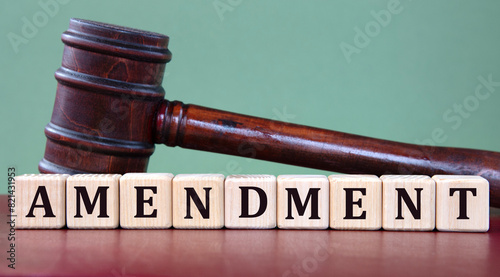 AMENDMENT - word on wooden cubes on background of judge's gavel
