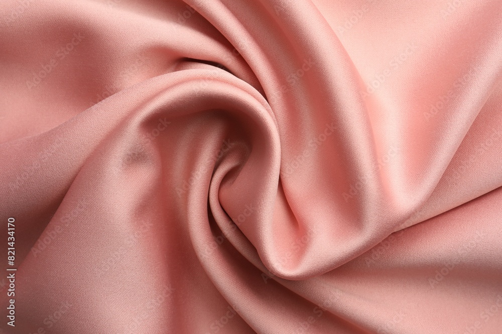 Obraz premium Crumpled pink silk fabric as background, top view