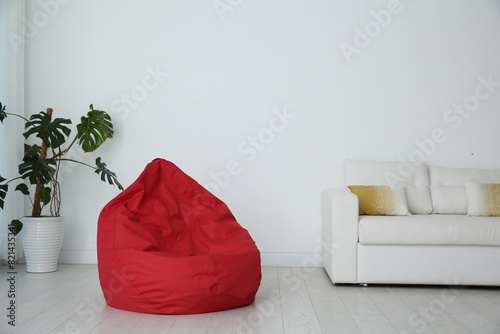 Red bean bag chair on floor in room