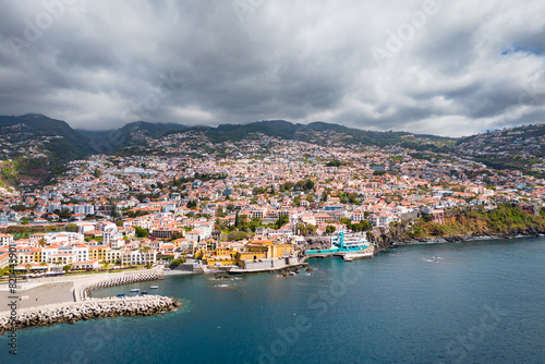 Aerial view of a drone flight over Funchal coastline in Madeira island in sunny day