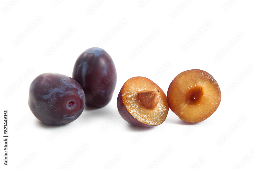 Fototapeta premium Two Whole and Halves purple plums isolated on white background. .