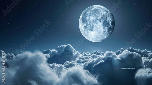 A large moon is shining brightly in the night sky  surrounded by fluffy clouds