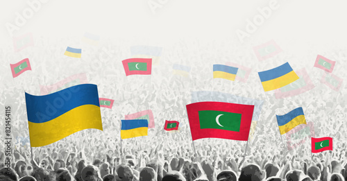People waving flag of Maldives and Ukraine, symbolizing Maldives solidarity for Ukraine.