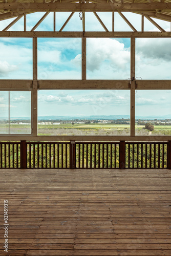 Wooden structure with parquet and large windows with a beautiful landscape on the horizon