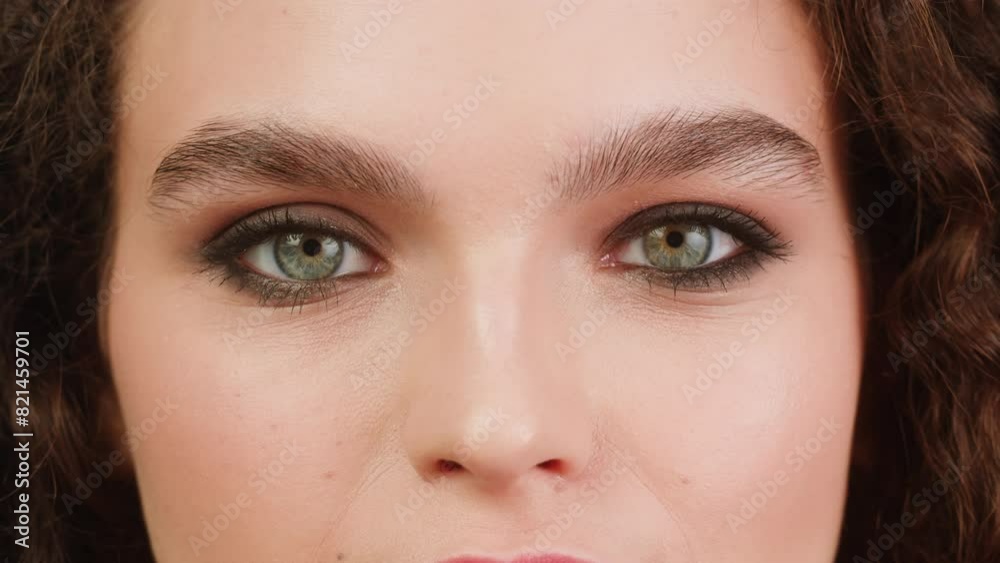 Young attractive brunette woman with curly hair looking and smiling at the camera close-up, Female with smoky eyes make-up. Makeup tutorial. Young attractive brunette woman with curly hair looking and smiling at the camera close-up, Female with smoky eyes make-up. Makeup tutorial.