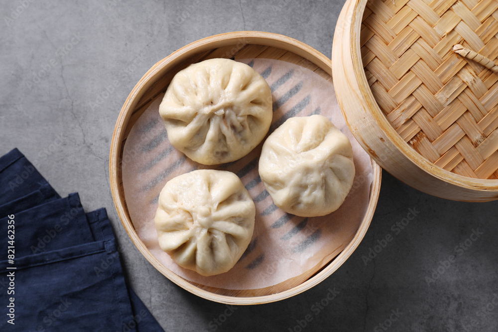 Delicious bao buns (baozi) on grey table, top view Delicious bao buns (baozi) on grey table, top view
