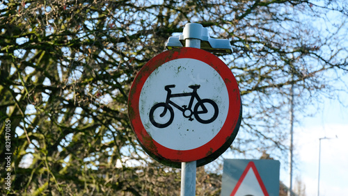 A view of bike symbol on red and white round sign depicting cycling path in the UK