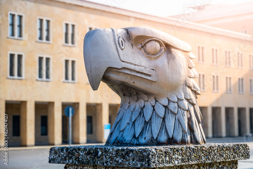 A detailed sculpture of an eagles head by Wilhelm Lemke  set against the backdrop of terminal building of Tempelhof Airport. Eagle Square  Berlin  Germany