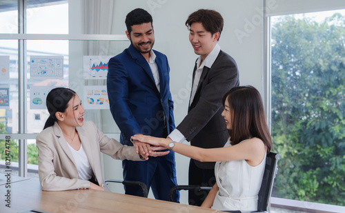 business team woman and man asian group stand on wall white looking and shake hand with in agreement cooperate successful  new project ready for happy enjoy working online sale inside home office © Singh