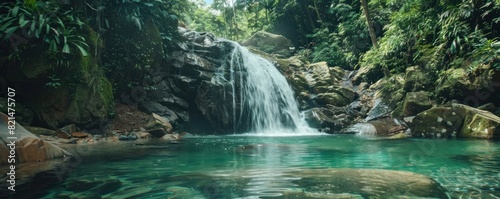 A beautiful waterfall surrounded by lush green trees and a clear blue river. The water is calm and peaceful  creating a serene atmosphere