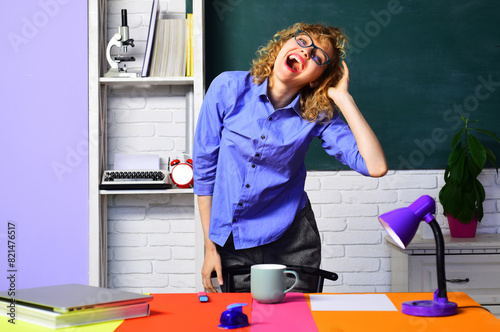 Teachers job. Happy female teacher in classroom. Smiling student girl at university campus. Back to school. Beautiful teacher in glasses near chalkboard. High school. Student taking exam in college.