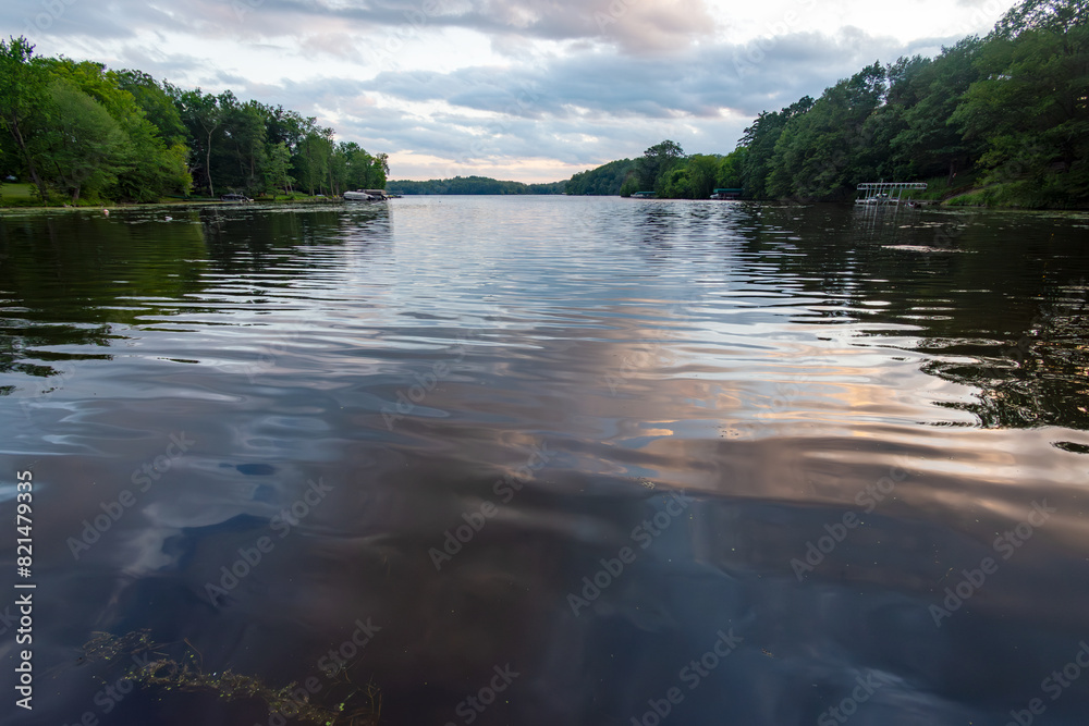 Looking out onto a Wisconsin northwoods lake as the last rays of sunlight begin to fade. Many boats have returned from fishing for the evening Looking out onto a Wisconsin northwoods lake as the last rays of sunlight begin to fade. Many boats have returned from fishing for the evening