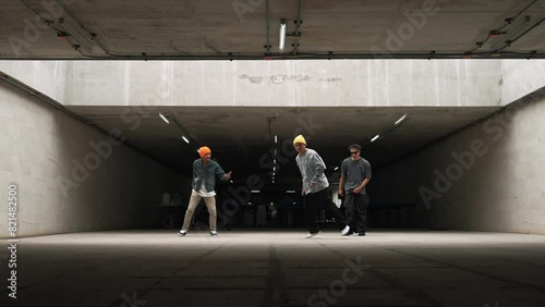 Group of hipster doing freeze pose while dancer team dancing together. Professional break dancer team perform street dance at building with funny and lively movement. Outdoor sport 2024. Sprightly.