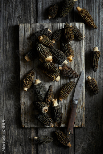 Black morels on a gray wooden background photo