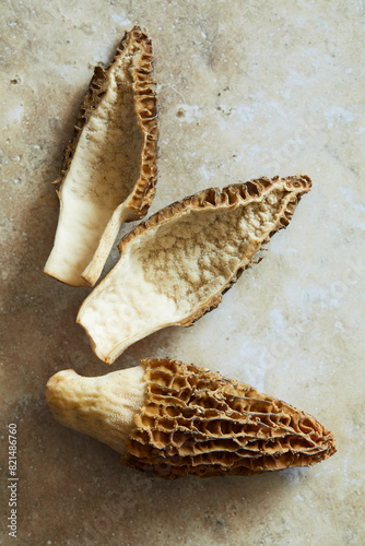 Close up black morels on a beige stone background photo