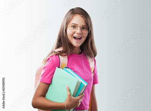 Middle school teen student holding books.