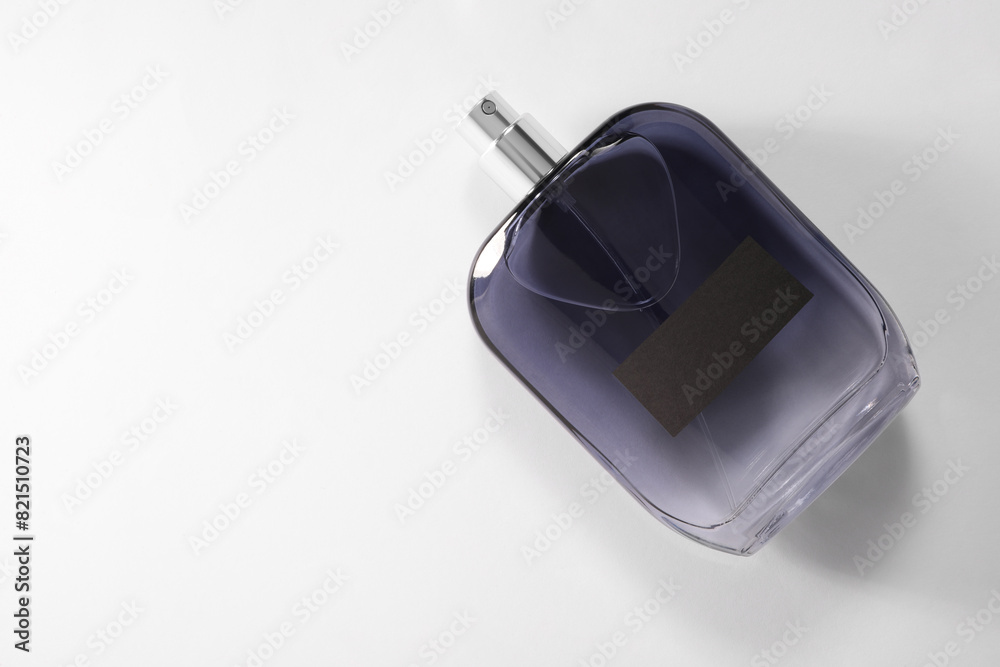 Luxury men`s perfume in bottle on white background, top view. Space for text Luxury men`s perfume in bottle on white background, top view. Space for text