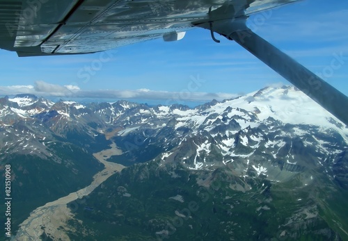 views of tidal flats, glaciers, and mountain peaks  on a sunny sumer day while flying to chinitna bay in lake clark national park, near homer , alaska    