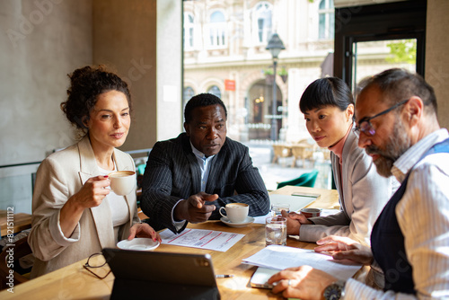 Business meeting in a cafe with diverse professionals photo