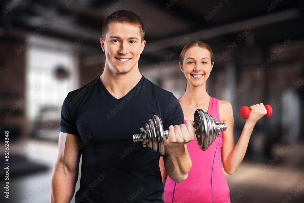 Serious man weightlifting in workout at indoor gym. Serious man weightlifting in workout at indoor gym.