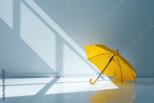 Open yellow umbrella on the clean white floor in the room