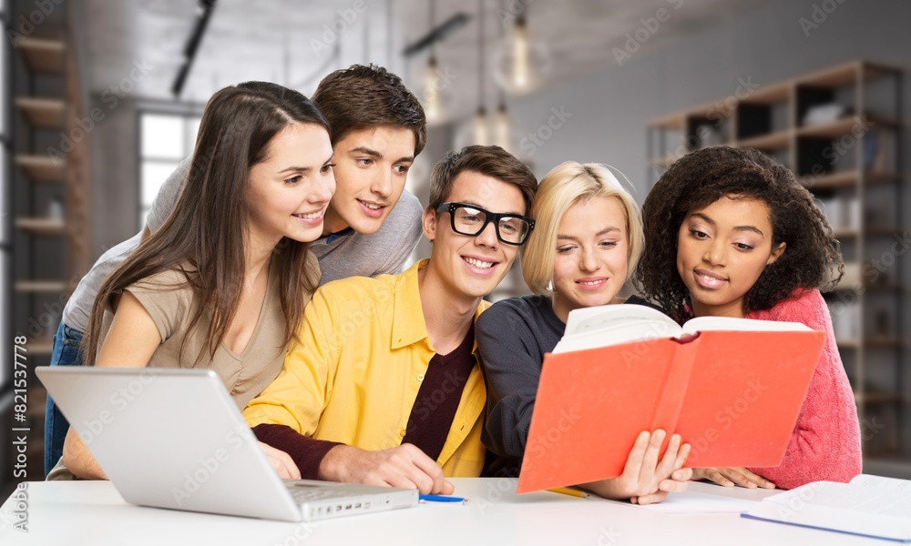 Happy young students team in library Happy young students team in library
