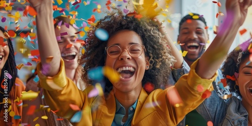 A group of diverse people are celebrating with confetti falling over them.