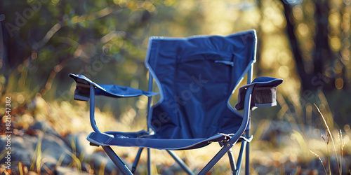 Indigo blue camping chair: A camping chair with an indigo blue color is set up in the wilderness, waiting for someone to relax in