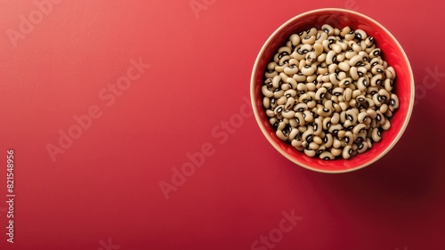 Bowl of black-eyed peas against red background photo