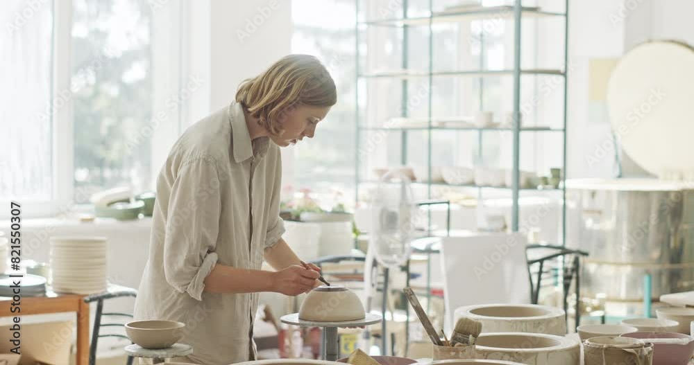 Potter Couple Collaborating in Bright Ceramic Studio Potter Couple Collaborating in Bright Ceramic Studio